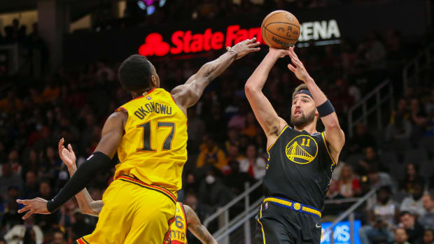 Mar 25, 2022; Atlanta, Georgia, USA; Golden State Warriors guard Klay Thompson (11) shoots over Atlanta Hawks forward Onyeka Okongwu (17) in the second quarter at State Farm Arena.